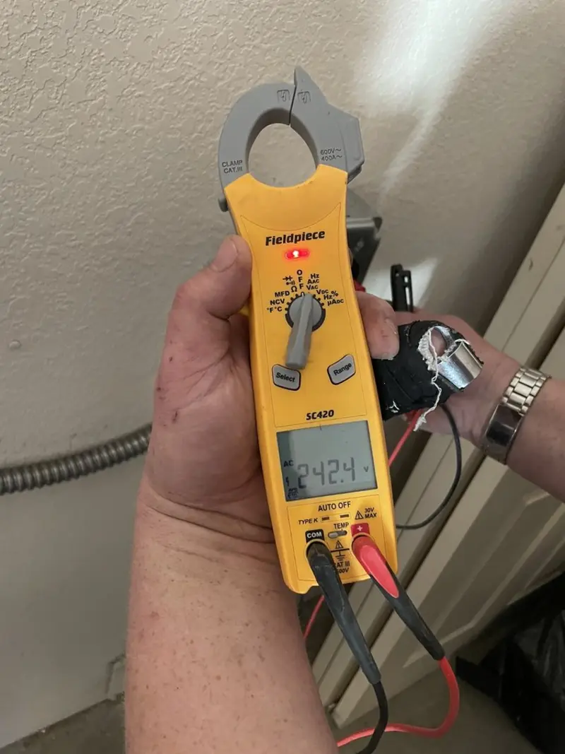 Voltage testing with clamp meter during Ceiling Fan Installation in Manitou Springs
